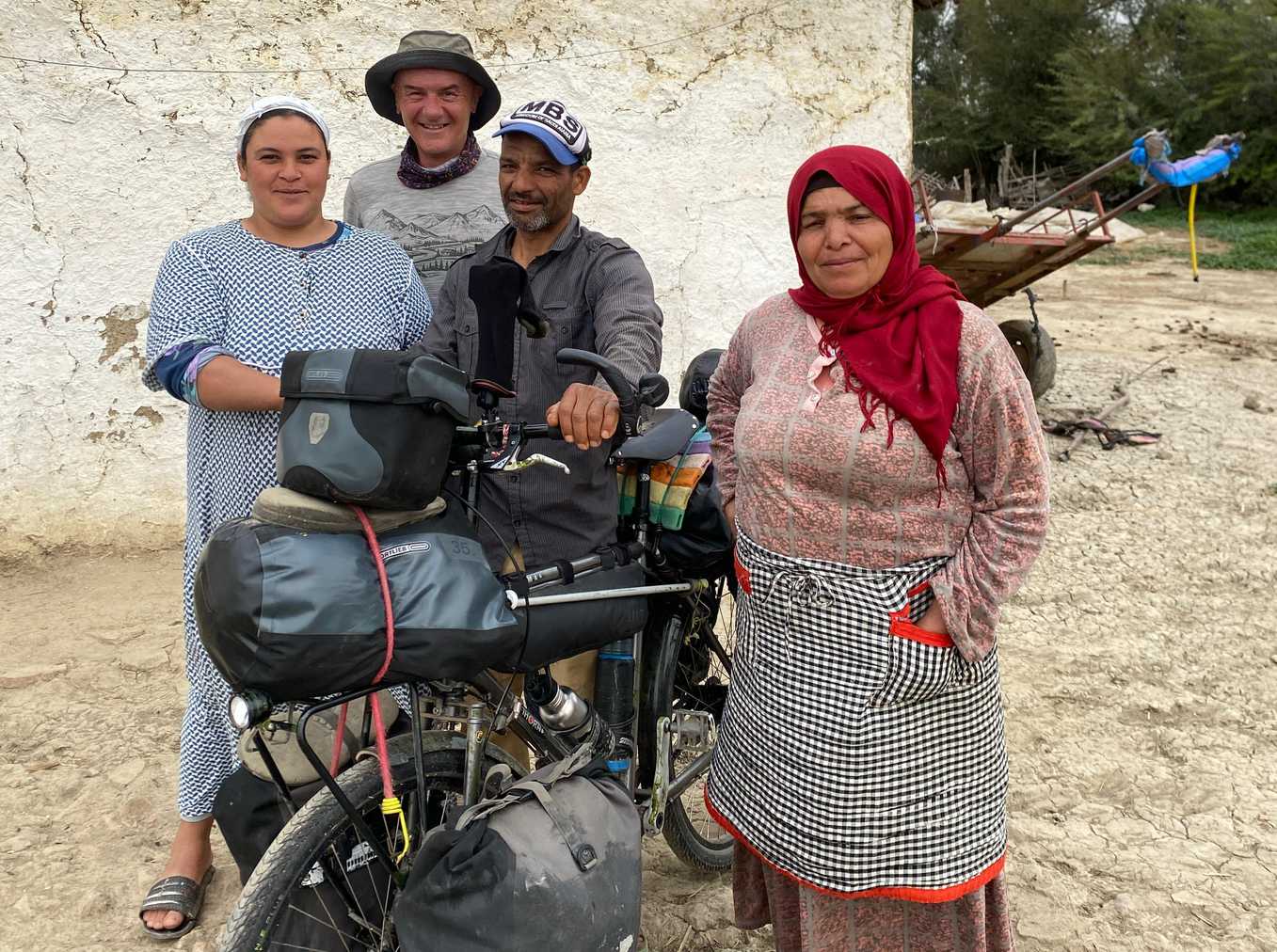 Paul stood by his motorbike next to a man a two Morrocan women