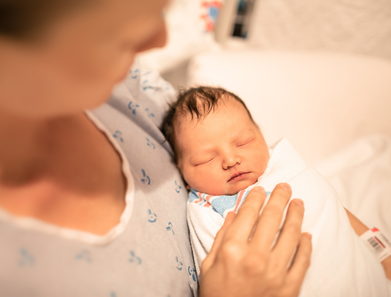 Mother holding their newborn baby in hospital