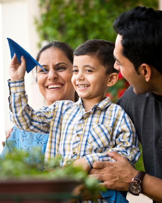 Young boy with parents smiling happily
