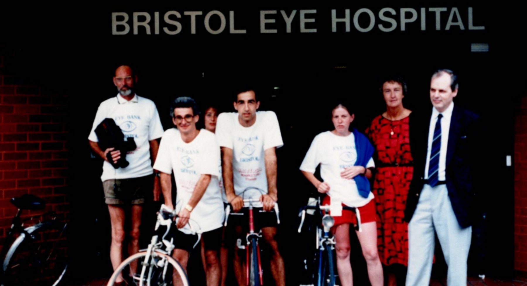 Graham (2nd left) holding bike in front of Bristol Eye Hospital. Prof Easty far right.