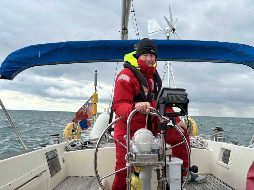 close-up of a man, Russell, steering a boat in a body of water