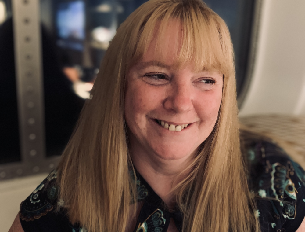 Tricia Sail smiling and looking away