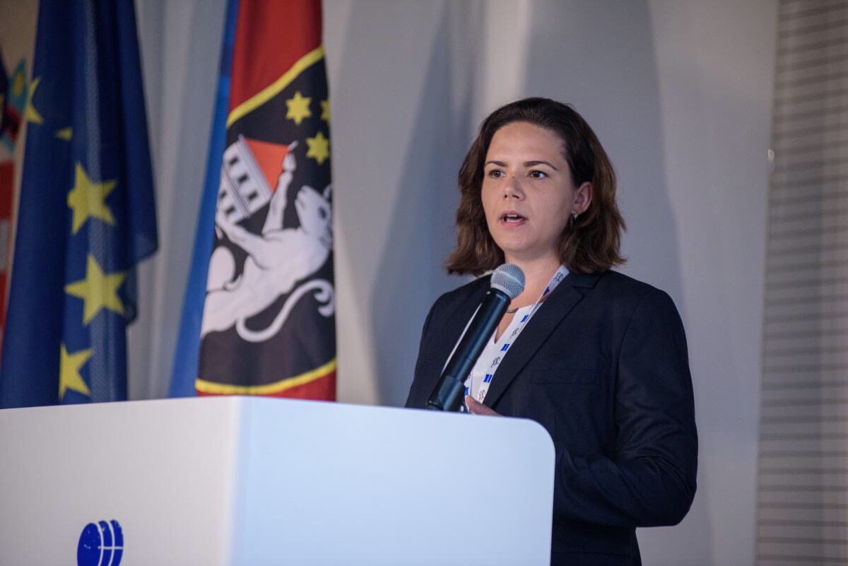 Dr Daniela Oehring stood at a podium speaking