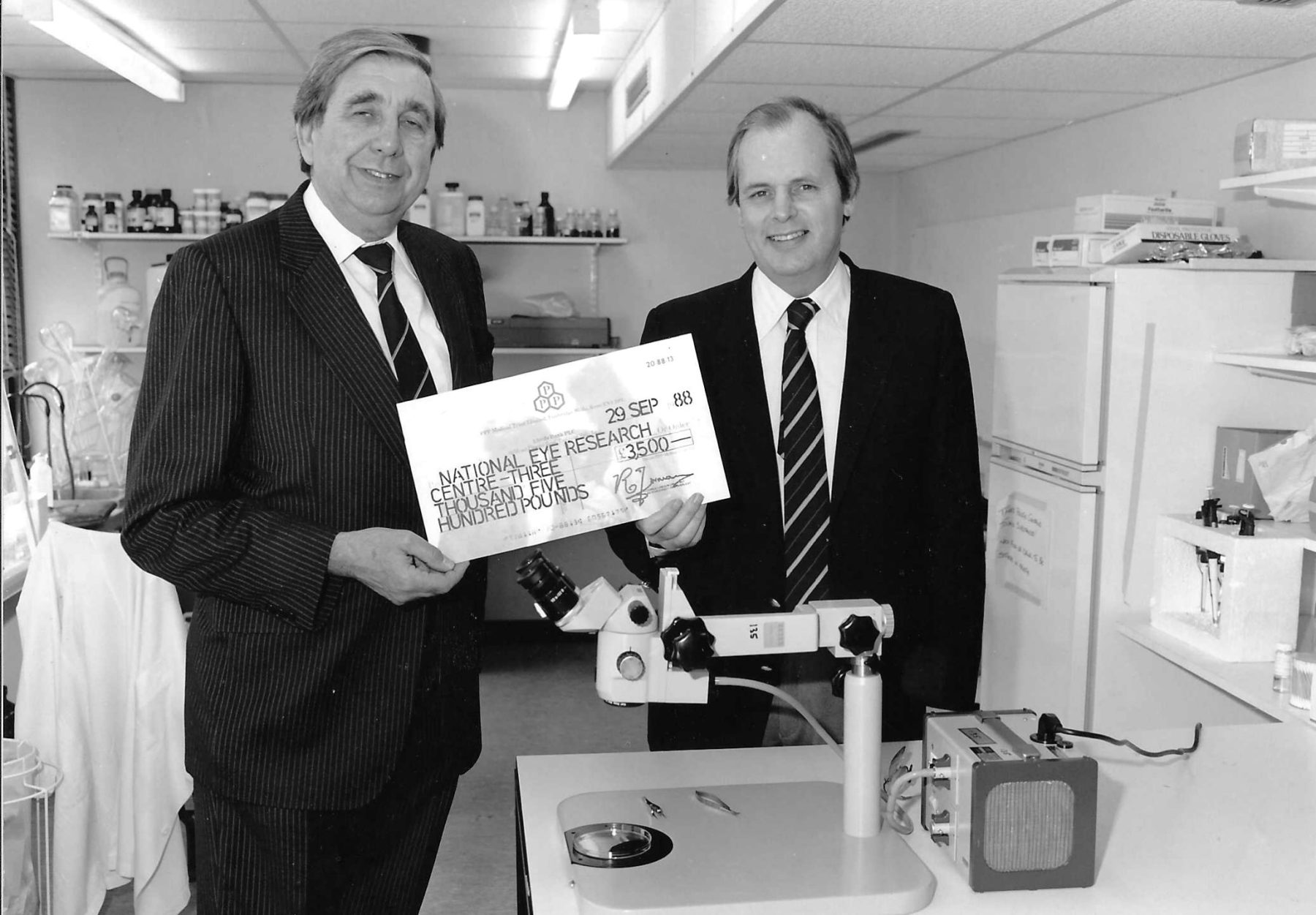 Two men holding a large cheque