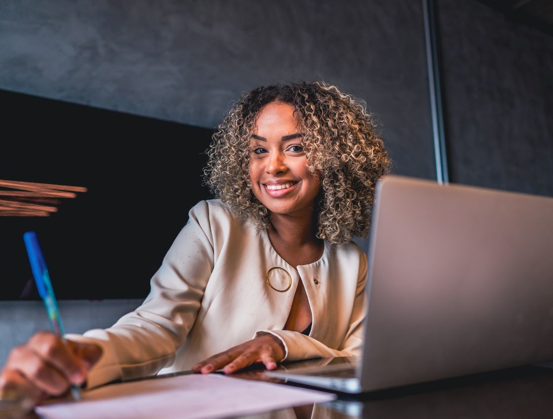 Person smiling in front of electronic device. Work with us webpage