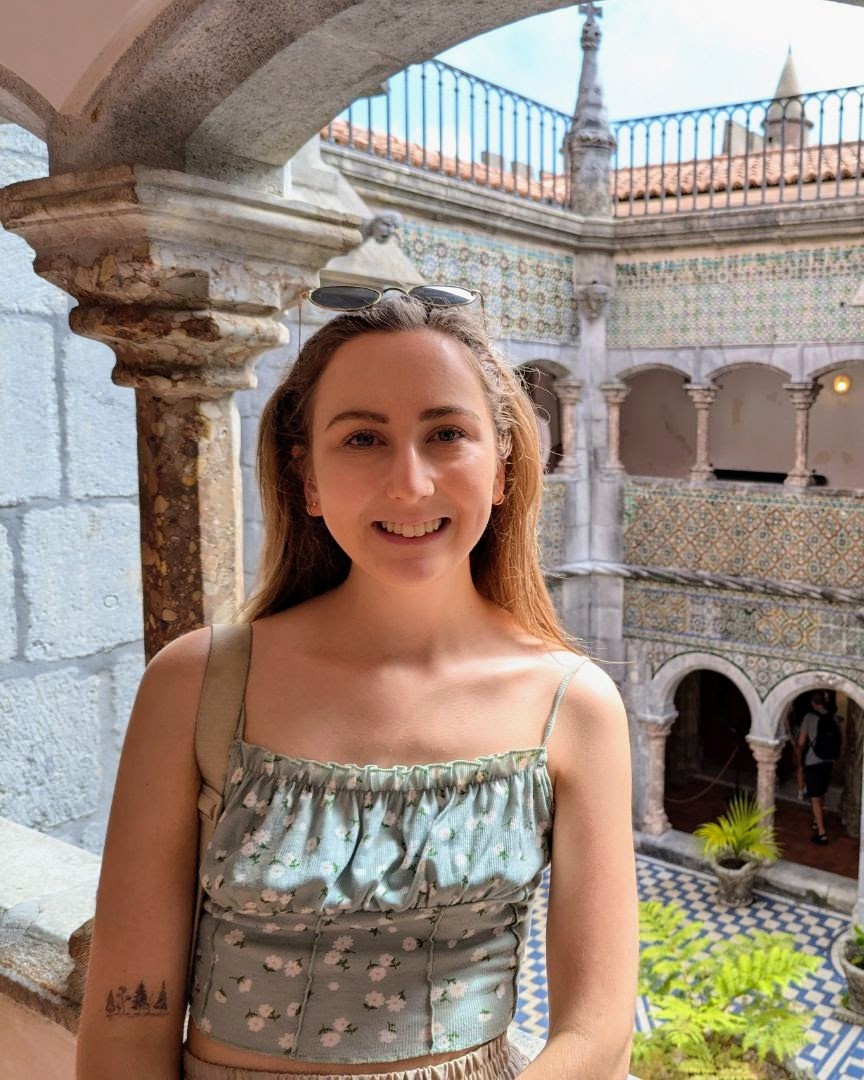 Georgina smiling in front of building