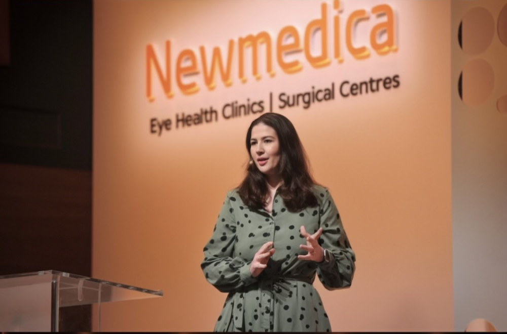 Holly in front of Newmedica signage