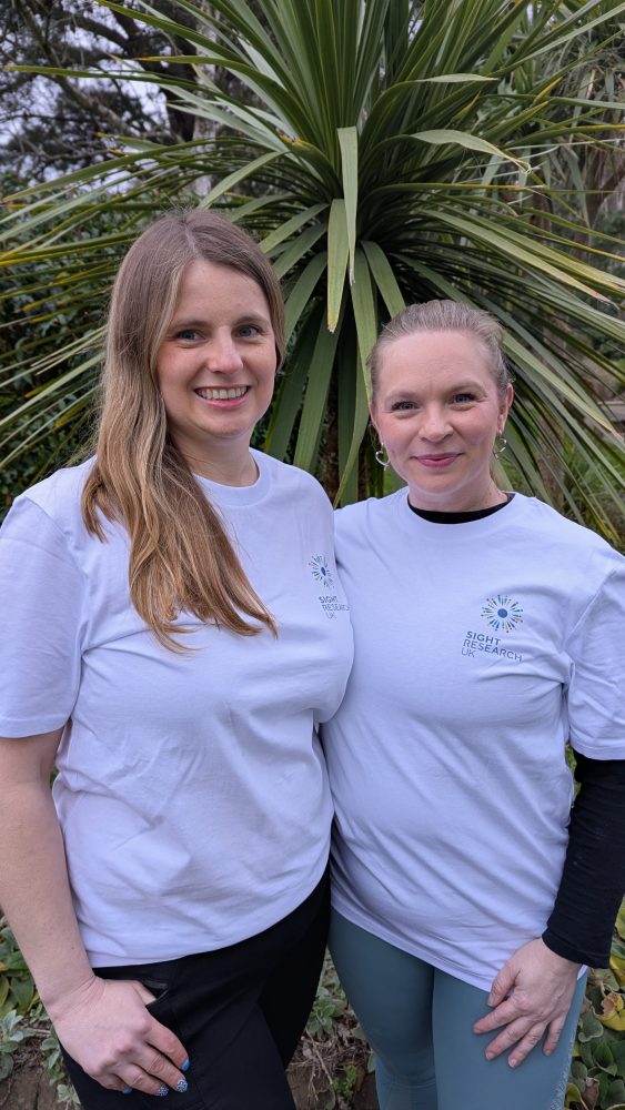 Kerri and Mickey in Sight Research UK T-shirts smiling in front of tree