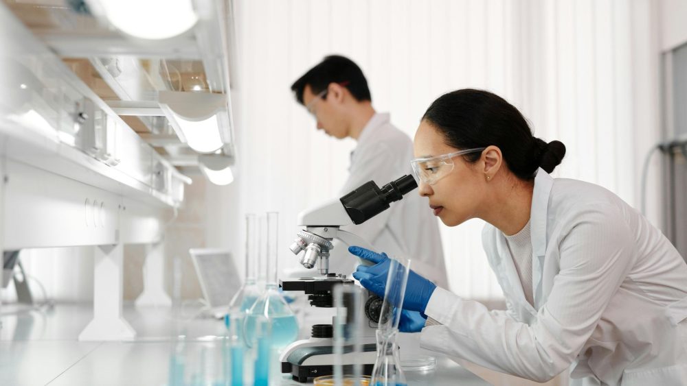 Scientist looking into microscope