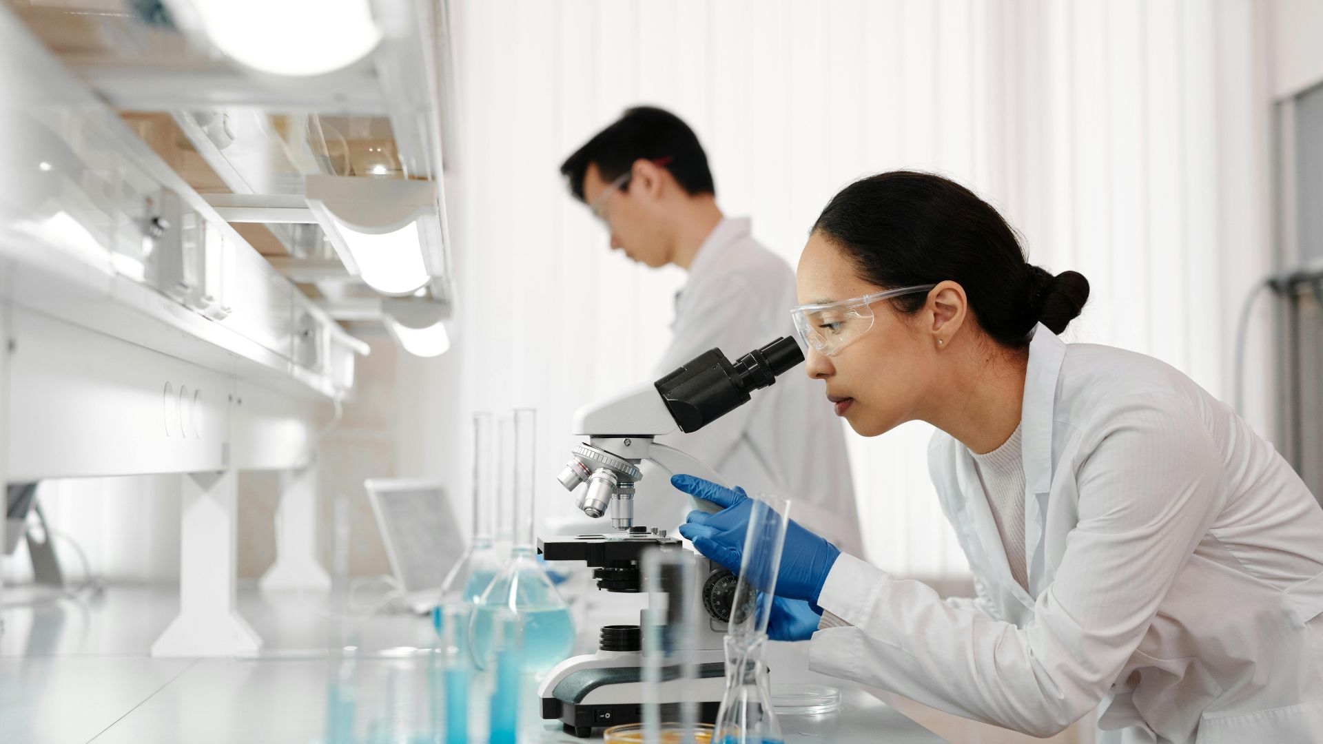 Scientist looking into microscope