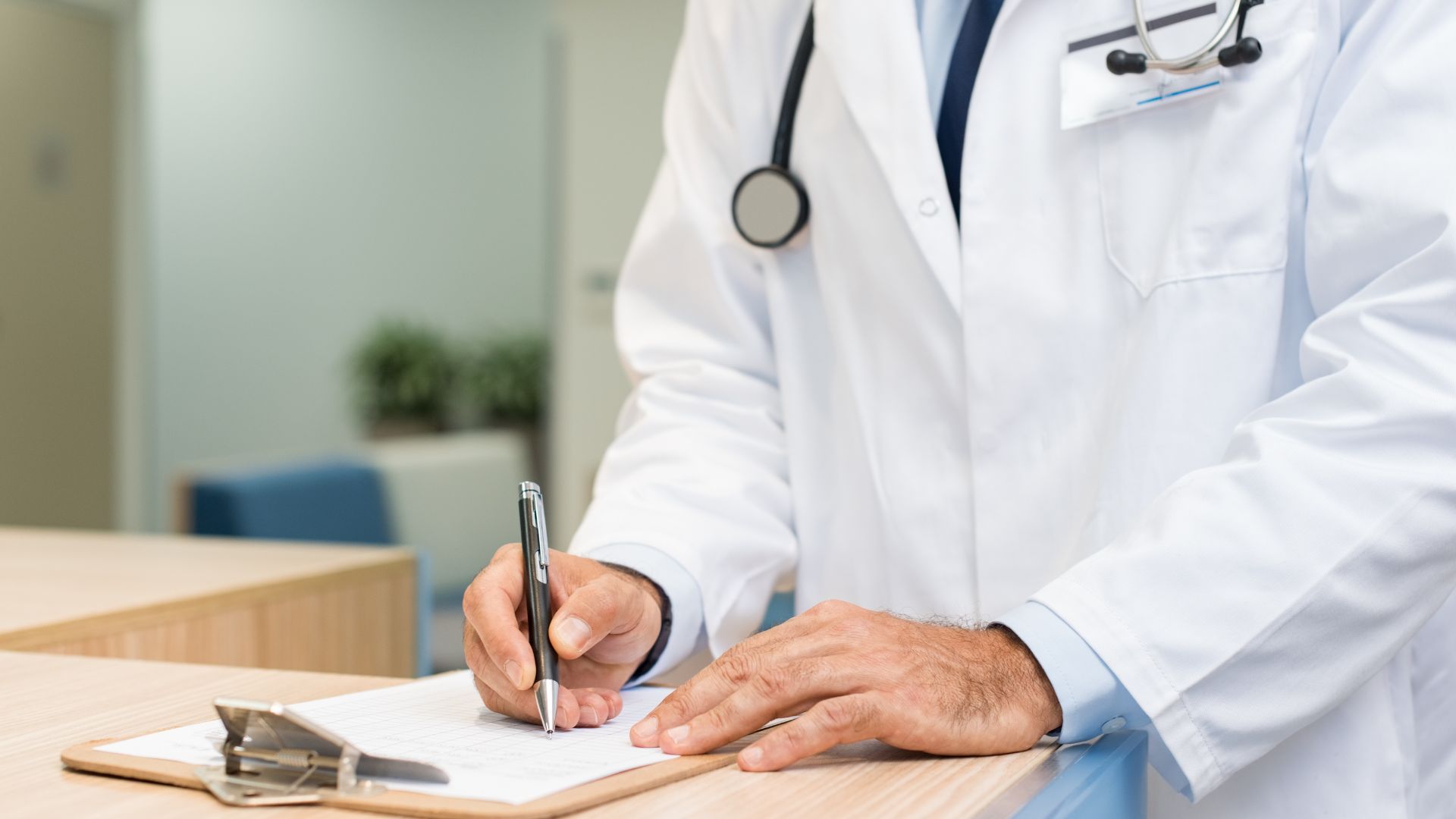 Medical professional writing on piece of paper
