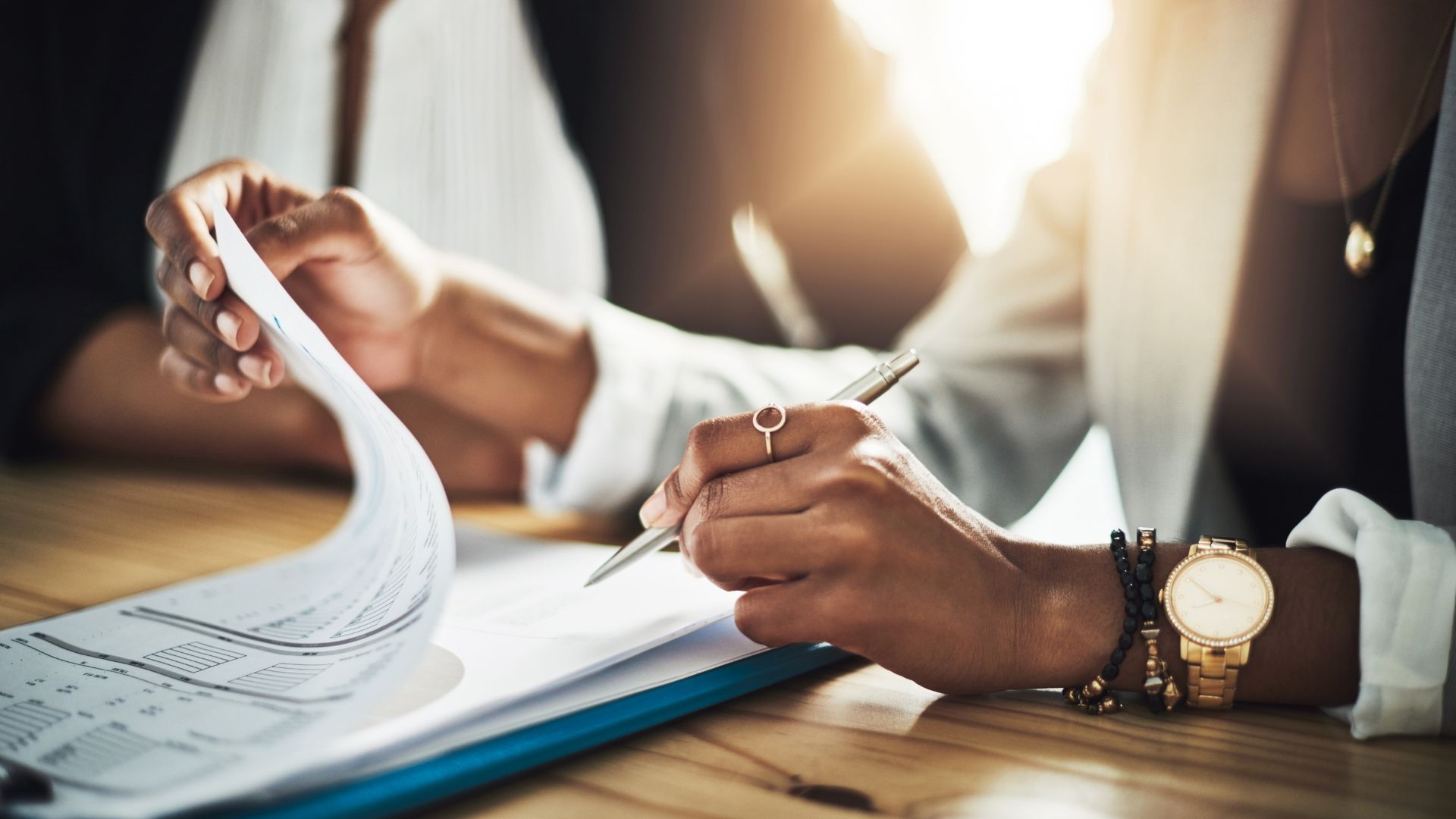Two people sat down looking at contract papers